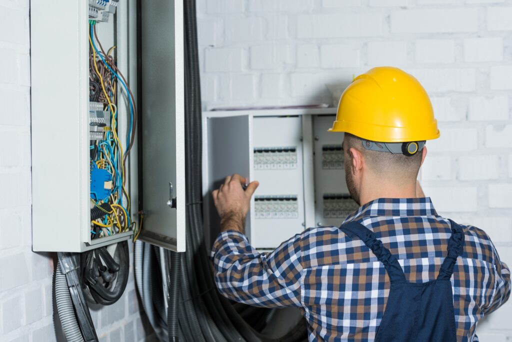 Male electrician repairing circuit line