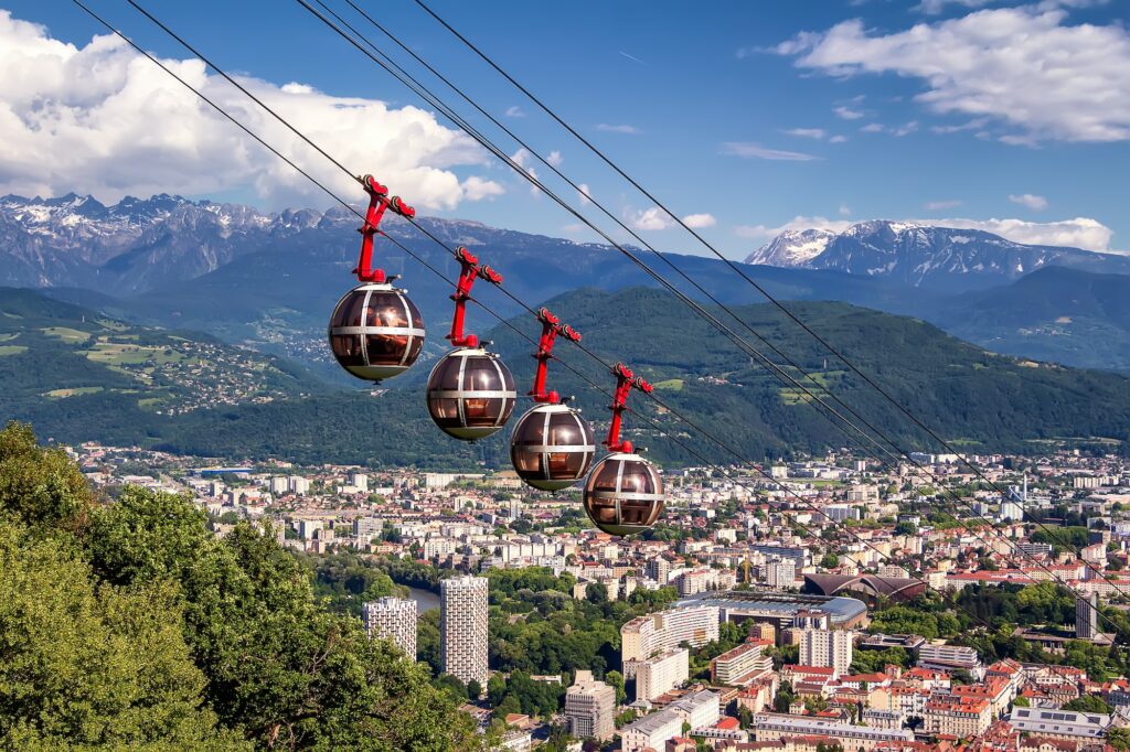 Aerial view on cable way and city. Grenoble, France. Grenoble-Bastille cable car on the foreground