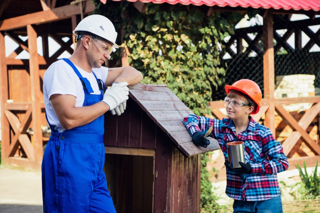 Father And Son Building Tree House Together Painting it With a Brush