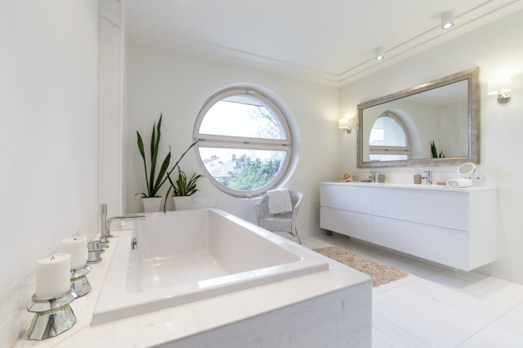 Minimalist white bathroom with a circulal window