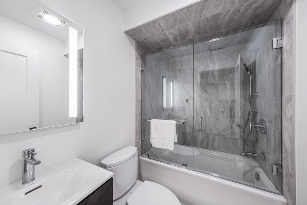 Stylish bathroom with a glass partitioned bathtub